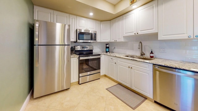 kitchen featuring sink, stainless steel appliances, and white cabinetry