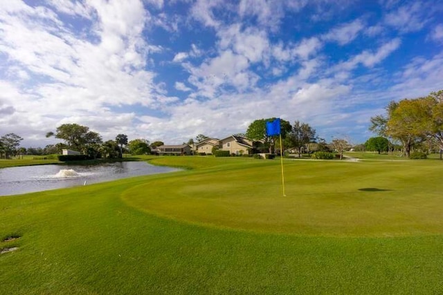 view of community featuring a water view and a lawn