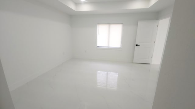 empty room with a raised ceiling