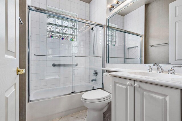 7357 Marbella Echo Dr, Delray Beach, FL 33446 - full bathroom featuring tile patterned floors, toilet, vanity, and bath / shower combo with glass door
