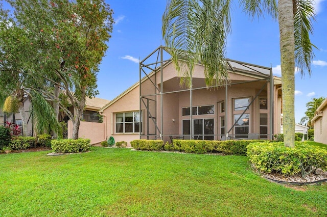 7357 Marbella Echo Dr, Delray Beach, FL 33446 - rear view of property with a yard and glass enclosure