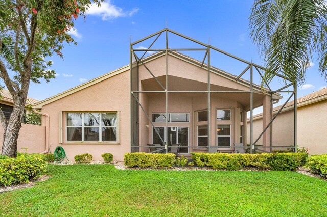 7357 Marbella Echo Dr, Delray Beach, FL 33446 - back of house featuring a lawn and glass enclosure