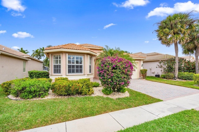 7357 Marbella Echo Dr, Delray Beach, FL 33446 - mediterranean / spanish-style home with a garage and a front yard