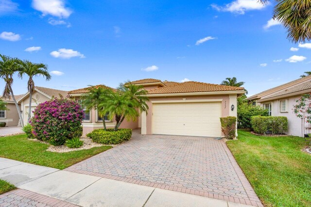 7357 Marbella Echo Dr, Delray Beach, FL 33446 - view of front of house with a front yard and a garage