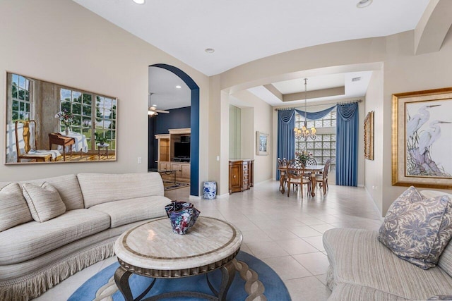 7357 Marbella Echo Dr, Delray Beach, FL 33446 - tiled living room with ceiling fan with notable chandelier and a raised ceiling