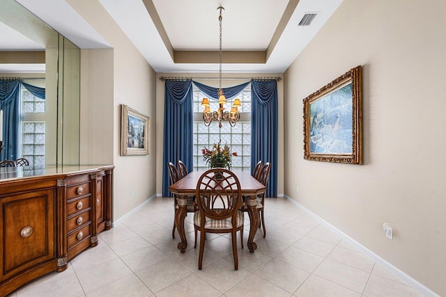 7357 Marbella Echo Dr, Delray Beach, FL 33446 - dining area featuring a tray ceiling, a notable chandelier, and light tile patterned floors