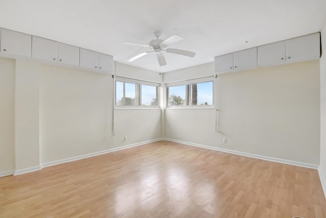 empty room with light wood-type flooring and ceiling fan