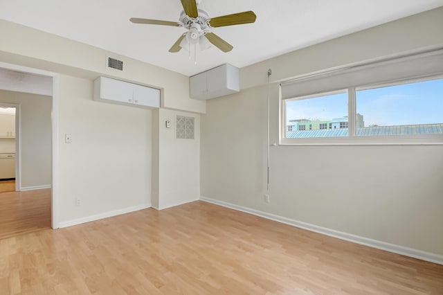 spare room featuring ceiling fan and light hardwood / wood-style flooring