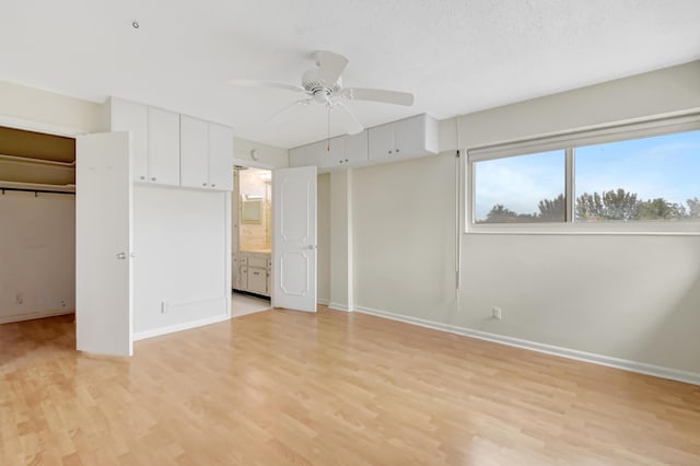 unfurnished bedroom with ceiling fan, light hardwood / wood-style flooring, and connected bathroom