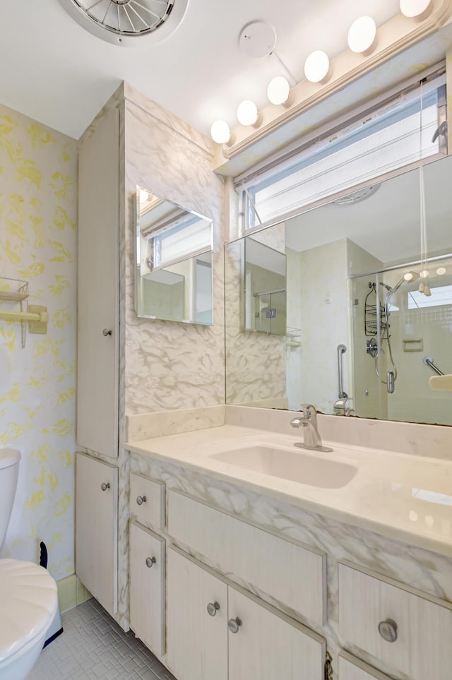 bathroom with an enclosed shower, vanity, and toilet