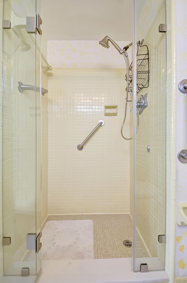 bathroom featuring a shower with door