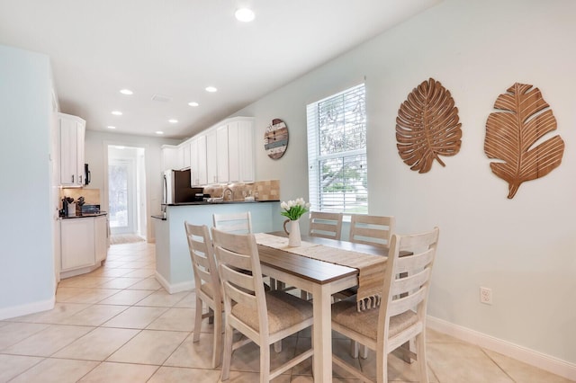 dining area with light tile patterned floors, baseboards, and recessed lighting