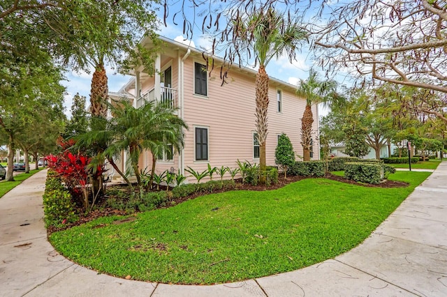 view of side of property with a lawn