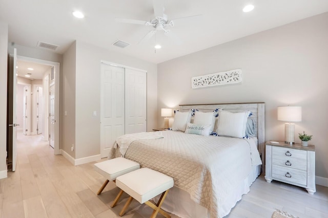 bedroom featuring recessed lighting, a closet, light wood-type flooring, and baseboards