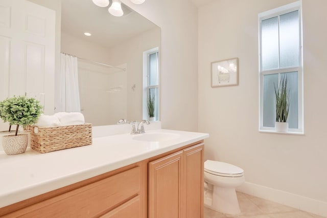 bathroom featuring toilet, a shower with shower curtain, vanity, a wealth of natural light, and tile patterned floors