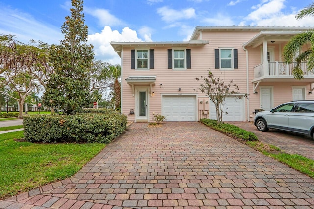 view of property featuring decorative driveway and an attached garage