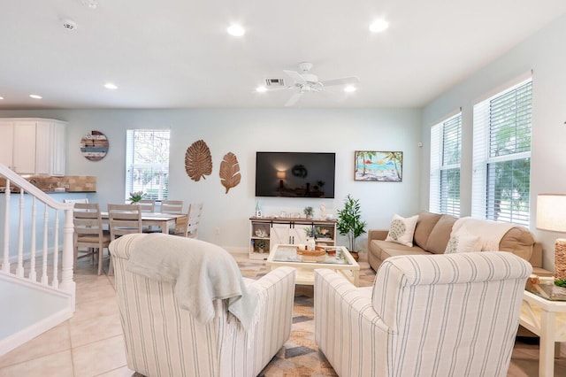 living area with light tile patterned floors, a wealth of natural light, visible vents, and recessed lighting