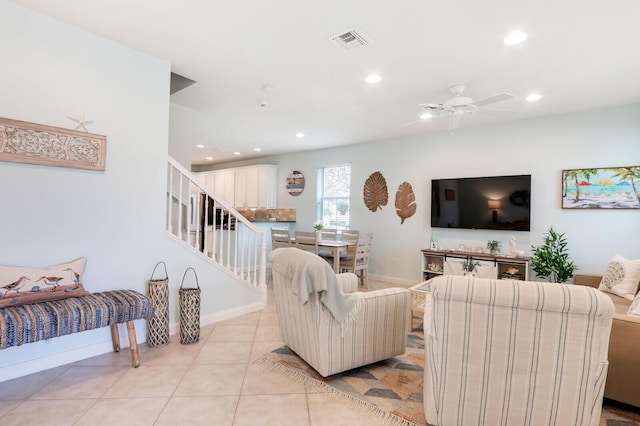 living area featuring light tile patterned floors, visible vents, a ceiling fan, stairs, and recessed lighting