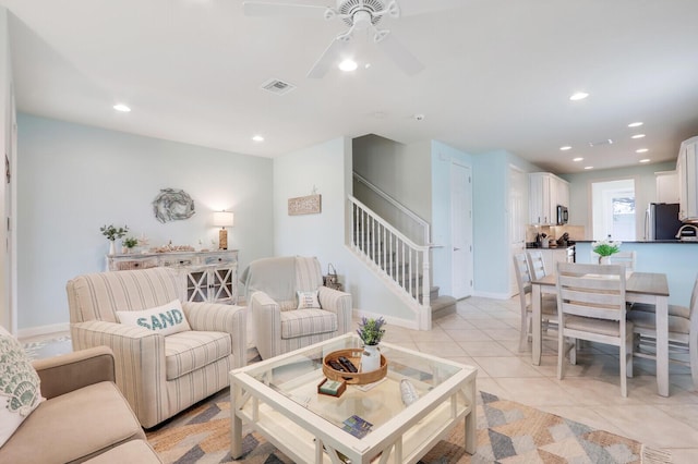 living area featuring light tile patterned floors, recessed lighting, visible vents, baseboards, and stairs