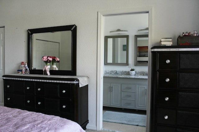 tiled bedroom featuring a sink