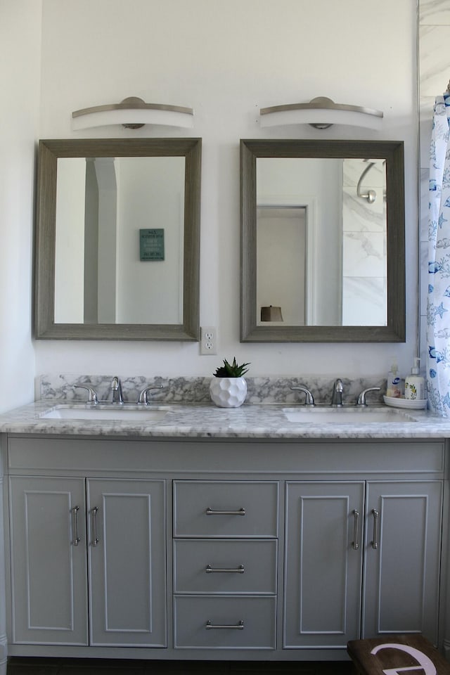 bathroom with a sink and double vanity