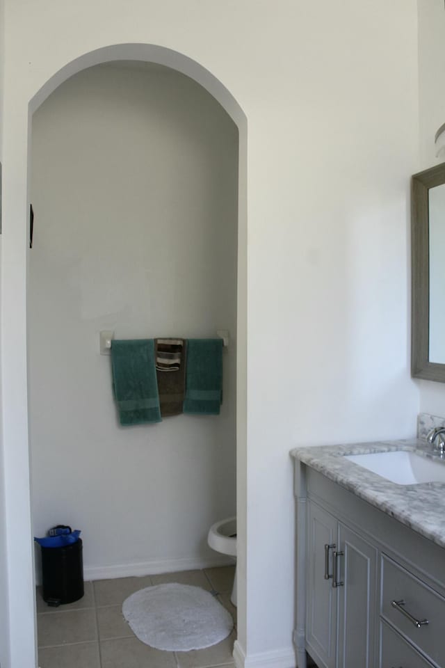 bathroom featuring tile patterned floors, toilet, and vanity