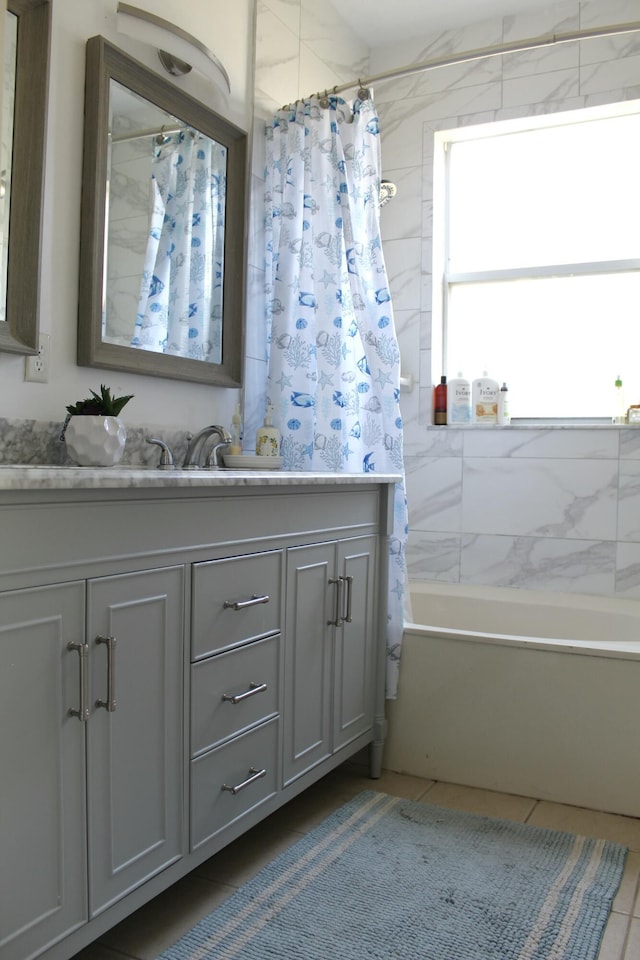 full bathroom with shower / bathtub combination with curtain, tile patterned flooring, and vanity