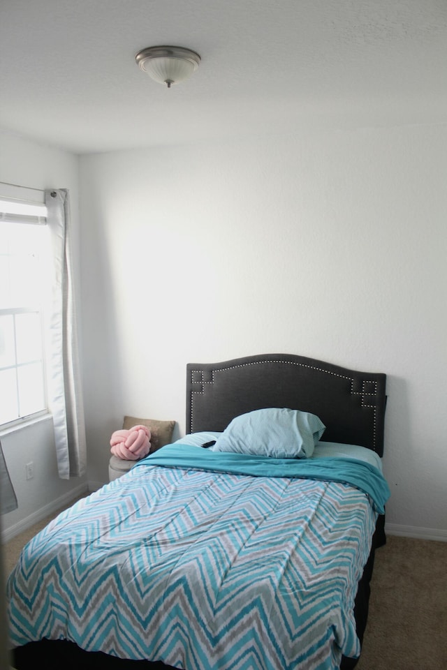 bedroom with carpet and baseboards