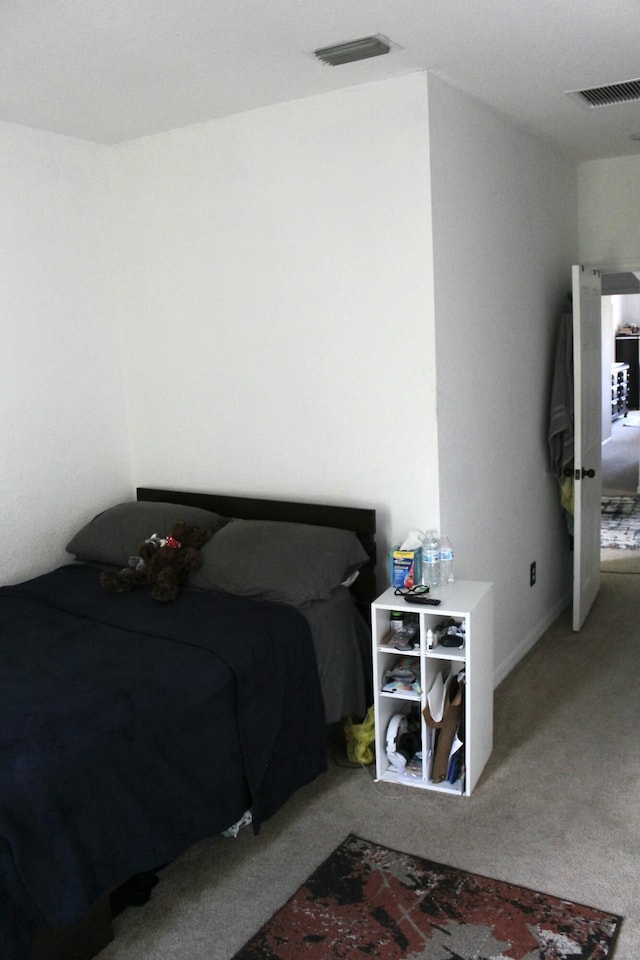 bedroom with visible vents and carpet floors