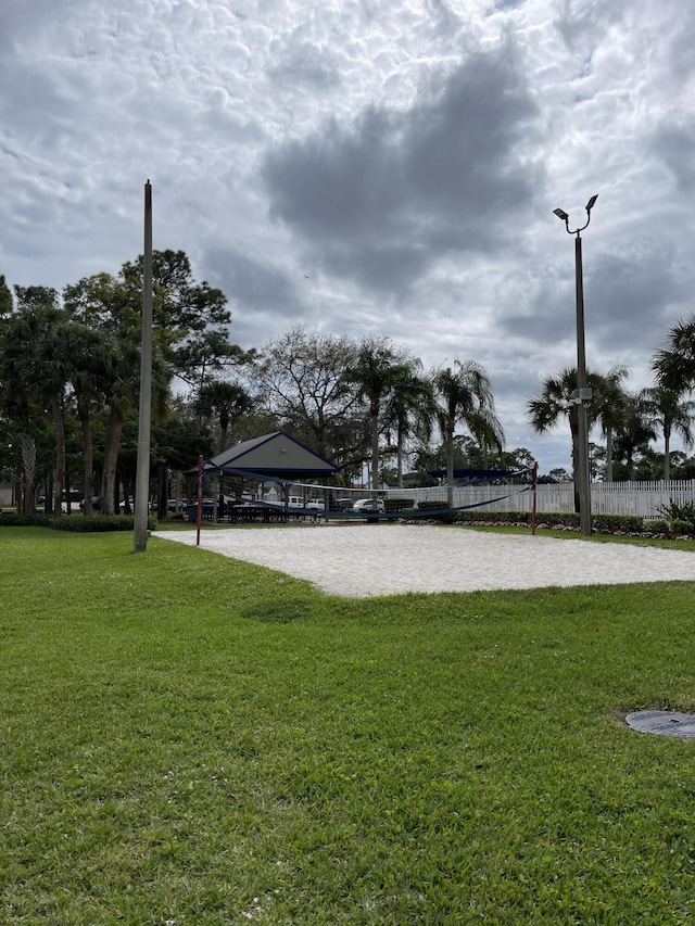 view of yard with a gazebo, fence, and volleyball court