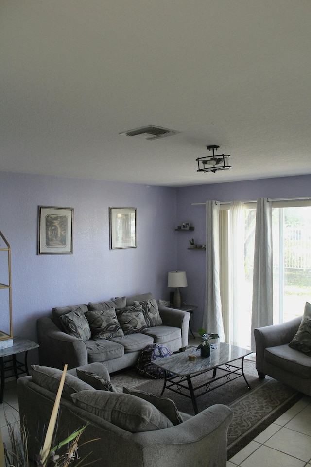living area featuring light tile patterned floors and visible vents