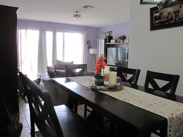 tiled dining area with a wealth of natural light and visible vents