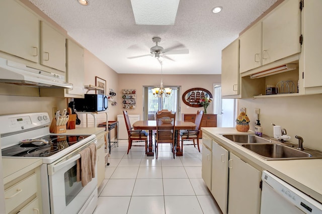 kitchen with sink, white appliances, and cream cabinets