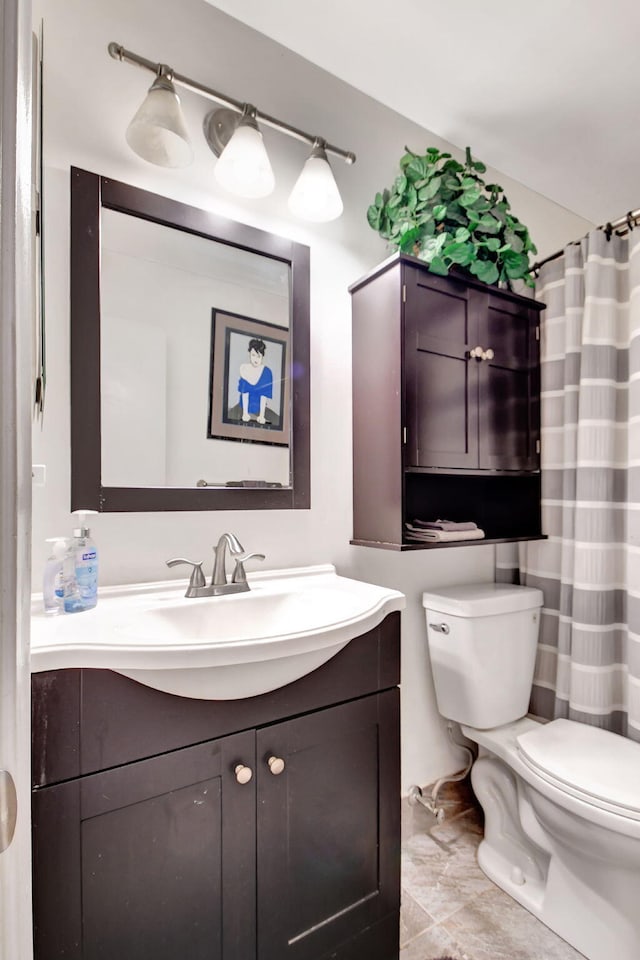 bathroom featuring toilet and vanity