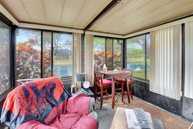 sunroom / solarium featuring a water view and wood ceiling