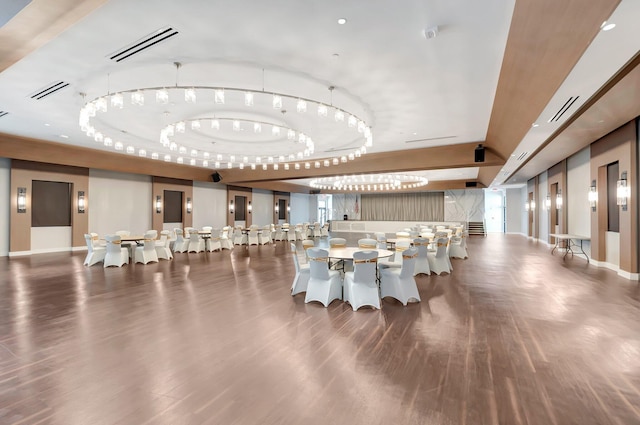 dining space featuring a tray ceiling and dark wood-type flooring