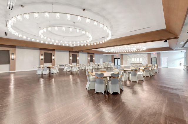 dining space with a raised ceiling and dark hardwood / wood-style floors