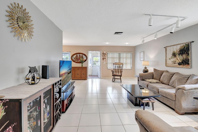 tiled living room with a textured ceiling