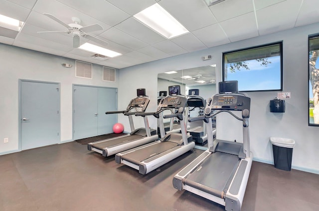 gym featuring a paneled ceiling and ceiling fan