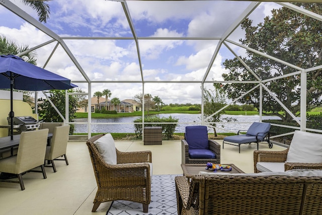 view of patio with a water view and a lanai