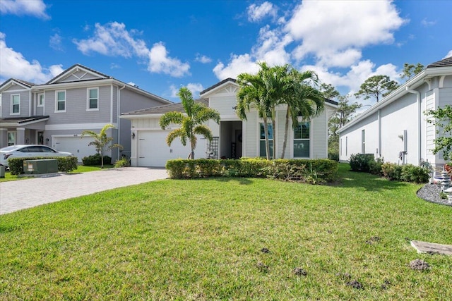 view of front of house featuring a front yard and a garage