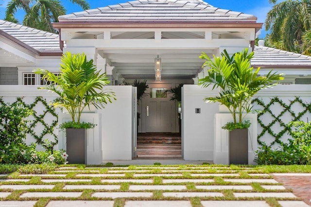 exterior space with a tiled roof and stucco siding