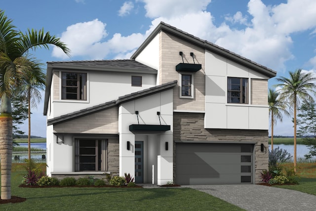 view of front of home with a front yard and a garage