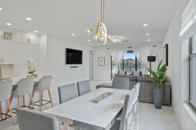 dining room featuring a notable chandelier, marble finish floor, and recessed lighting