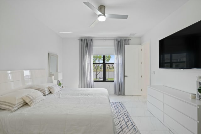 bedroom with marble finish floor, visible vents, and ceiling fan