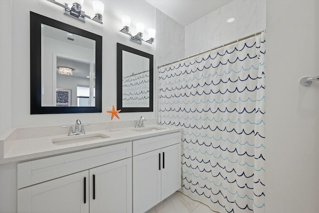 bathroom featuring a shower with curtain, marble finish floor, a sink, and double vanity