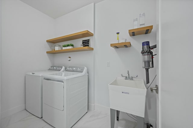 laundry room featuring marble finish floor, washing machine and dryer, laundry area, and baseboards