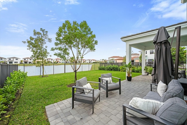 view of patio featuring a residential view, a fenced backyard, a water view, and an outdoor hangout area