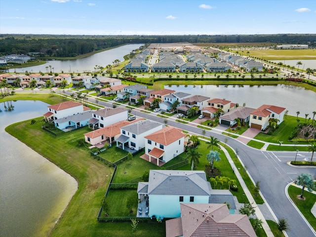 bird's eye view featuring a water view and a residential view