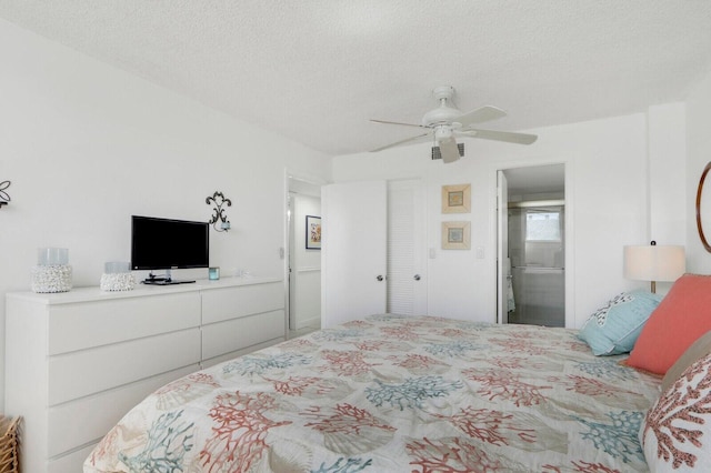 bedroom with a textured ceiling and a ceiling fan